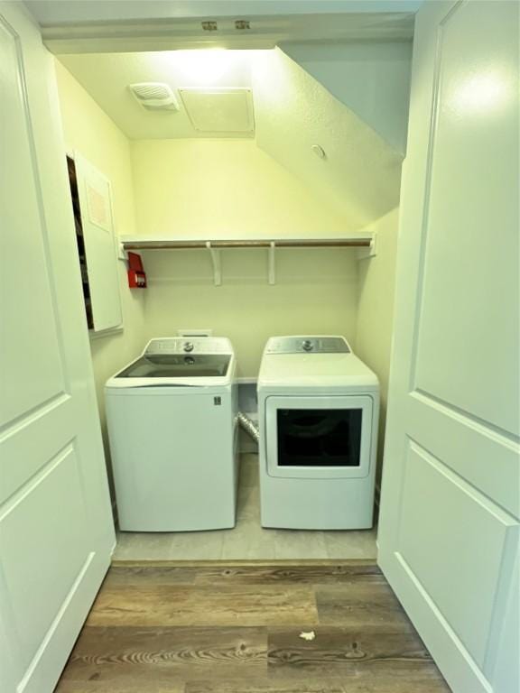 12001 Vista Parke Dr Unit 1202, Austin, TX 78726 - laundry room with wood finished floors and washing machine and clothes dryer