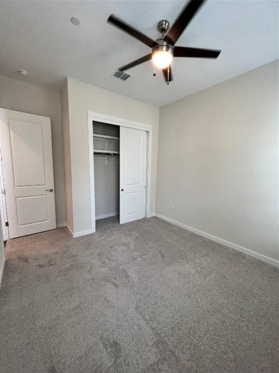 12001 Vista Parke Dr Unit 1202, Austin, TX 78726 - unfurnished bedroom with carpet flooring, a closet, and a ceiling fan
