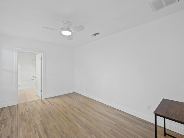 empty room with ceiling fan and light hardwood / wood-style flooring