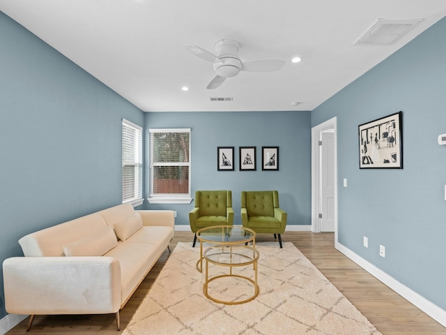 living room with hardwood / wood-style floors and ceiling fan