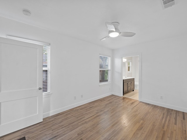 unfurnished bedroom featuring light wood-type flooring, connected bathroom, and ceiling fan