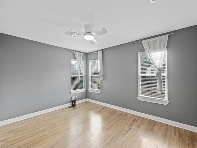 spare room featuring light hardwood / wood-style floors and ceiling fan