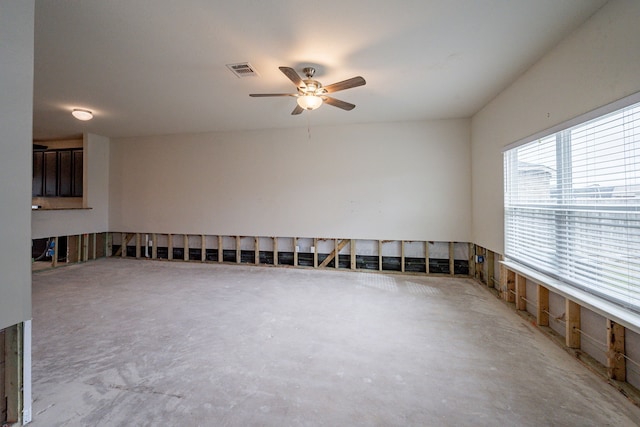 spare room featuring ceiling fan and concrete floors