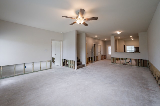 empty room with ceiling fan and concrete floors