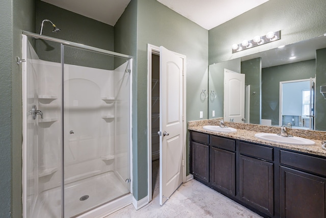 bathroom featuring walk in shower and vanity