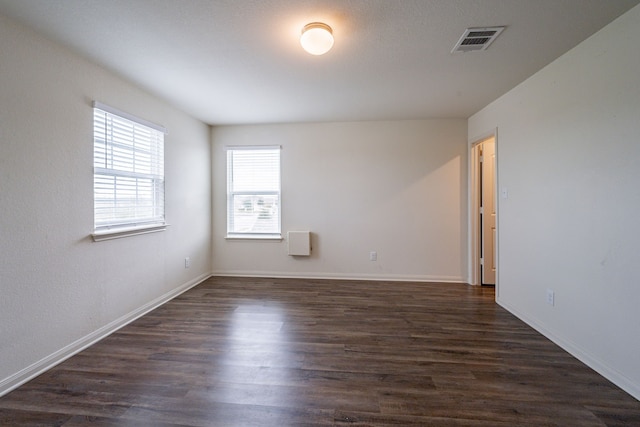 empty room with dark wood-type flooring