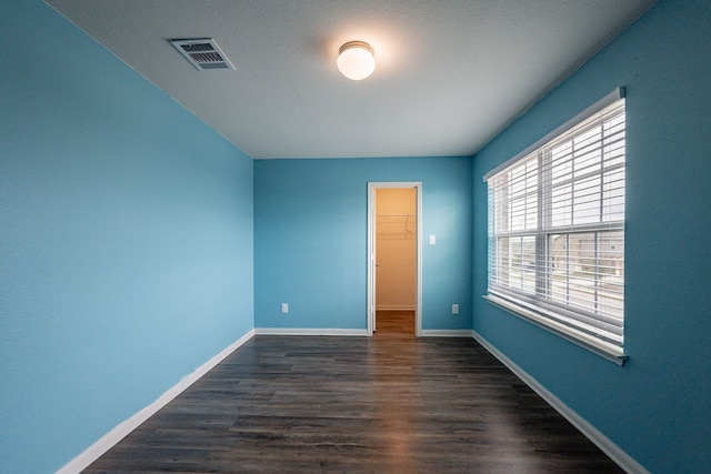 unfurnished room with dark hardwood / wood-style floors