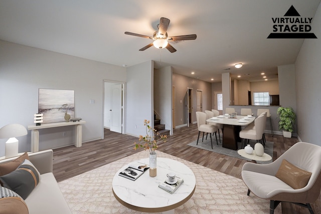 living room featuring ceiling fan and hardwood / wood-style floors