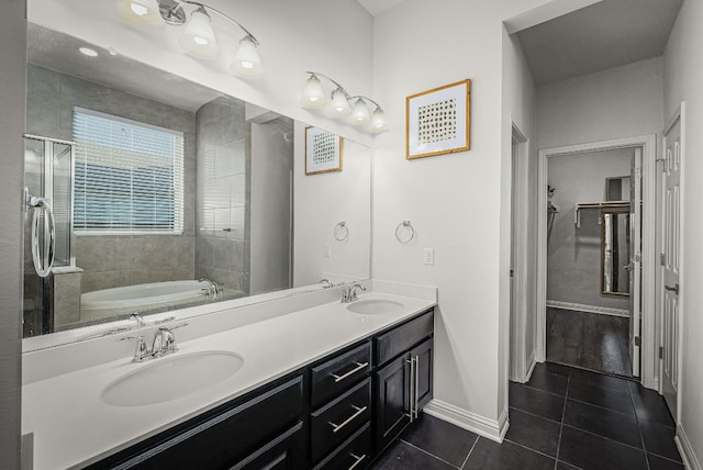 bathroom featuring vanity, shower with separate bathtub, and tile patterned floors