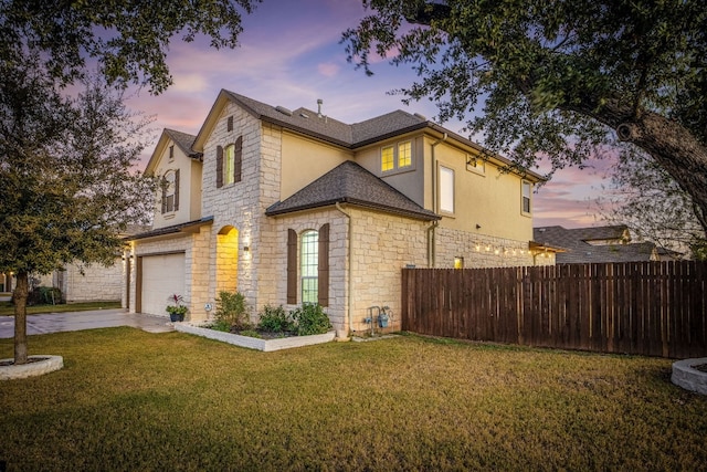 exterior space featuring a garage and a lawn