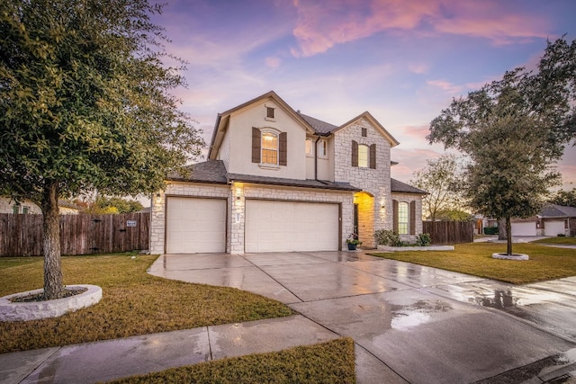 front of property featuring a garage and a yard