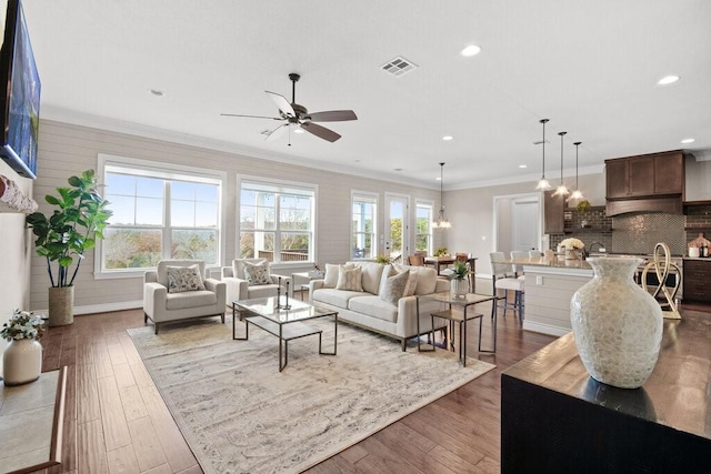 living room with ceiling fan, dark hardwood / wood-style floors, and ornamental molding