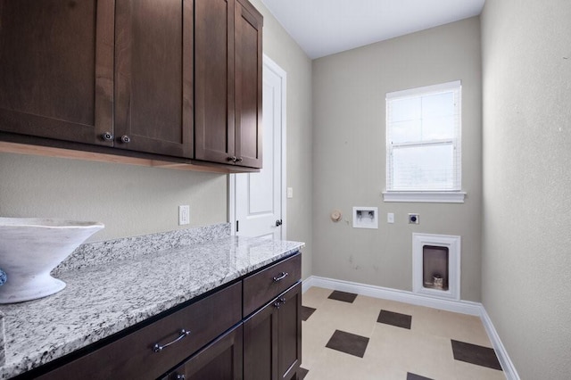 washroom with washer hookup, cabinets, and hookup for an electric dryer