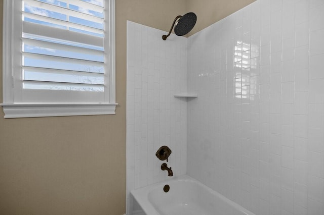 bathroom with plenty of natural light and tiled shower / bath combo