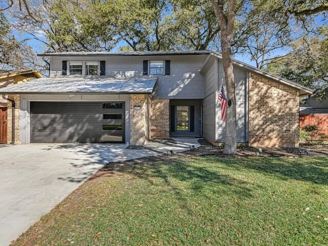 view of front of property featuring a garage and a front yard