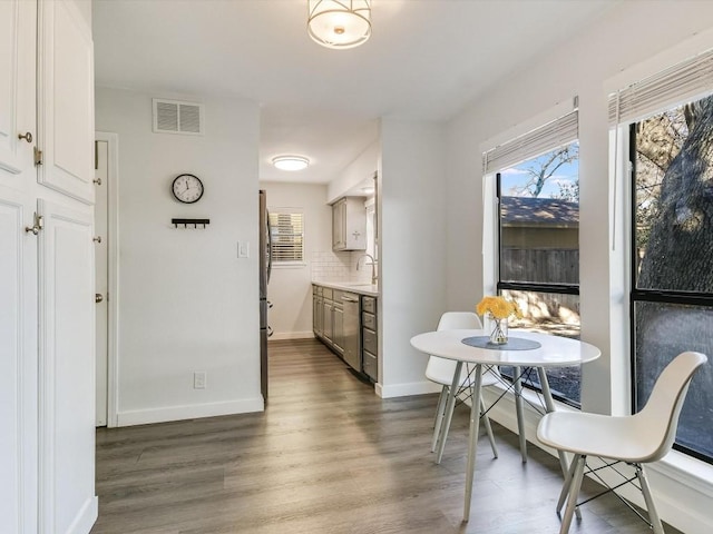 dining area featuring sink and hardwood / wood-style flooring