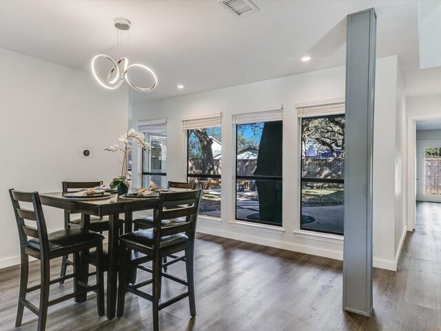 dining space featuring a chandelier and dark hardwood / wood-style flooring