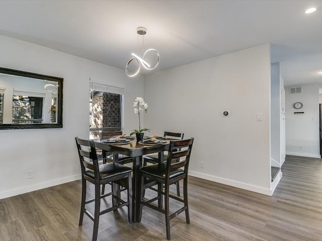 dining space with dark hardwood / wood-style floors