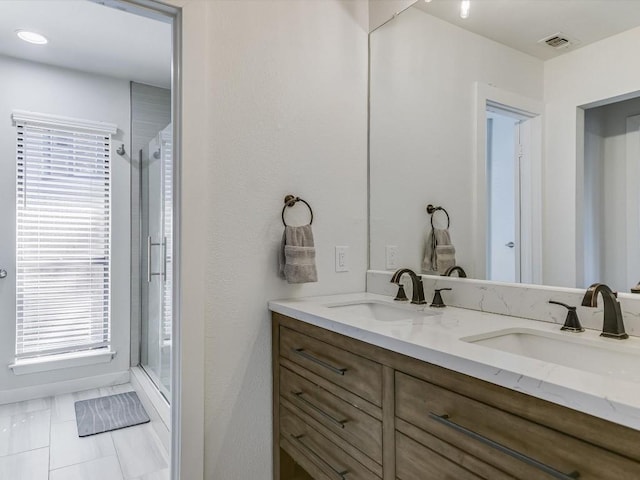 bathroom featuring vanity and a shower with shower door