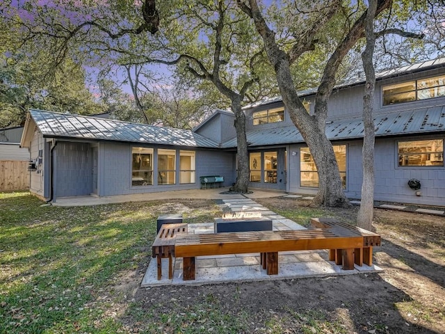 rear view of house featuring an outdoor living space and a yard