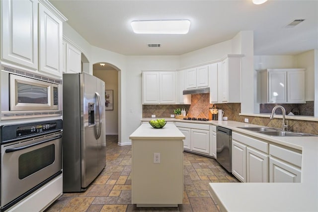 kitchen with sink, a center island, white cabinets, and appliances with stainless steel finishes