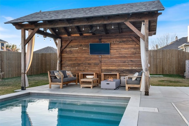 rear view of house with a gazebo, ceiling fan, a patio, and an outdoor living space with a fireplace