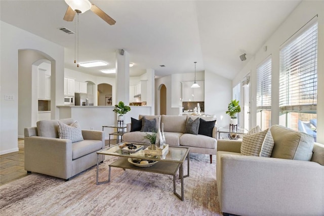 living room with ceiling fan and lofted ceiling