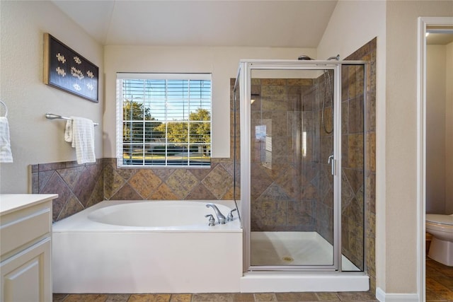 full bathroom featuring lofted ceiling, vanity, shower with separate bathtub, and toilet