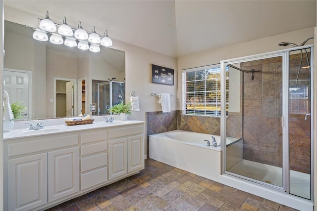 bathroom with vanity, separate shower and tub, and lofted ceiling