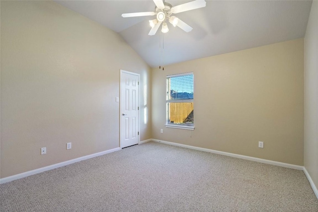 carpeted spare room with ceiling fan and lofted ceiling