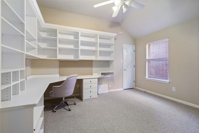 carpeted office space with ceiling fan and lofted ceiling