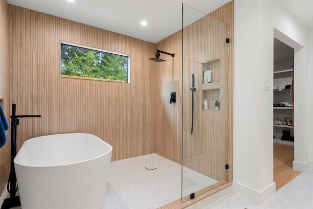 bathroom featuring independent shower and bath