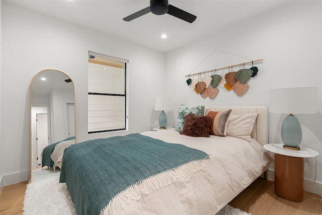 bedroom with ceiling fan and light wood-type flooring