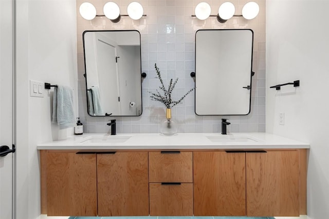 bathroom featuring vanity and tasteful backsplash