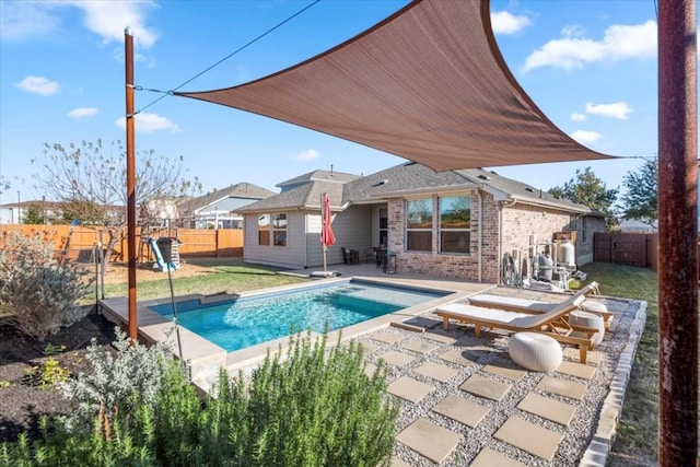 view of swimming pool with a lawn and a patio