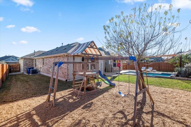 view of playground with a fenced in pool, central AC, and a yard