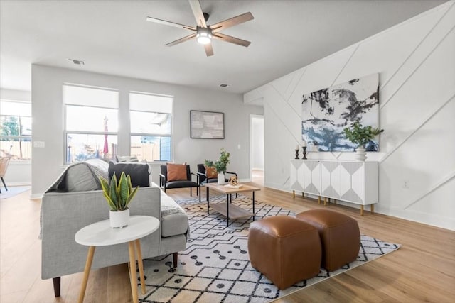 living room with ceiling fan and light hardwood / wood-style floors