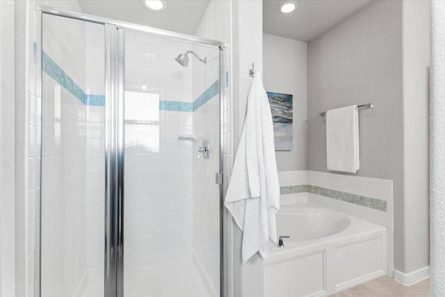 bathroom featuring separate shower and tub