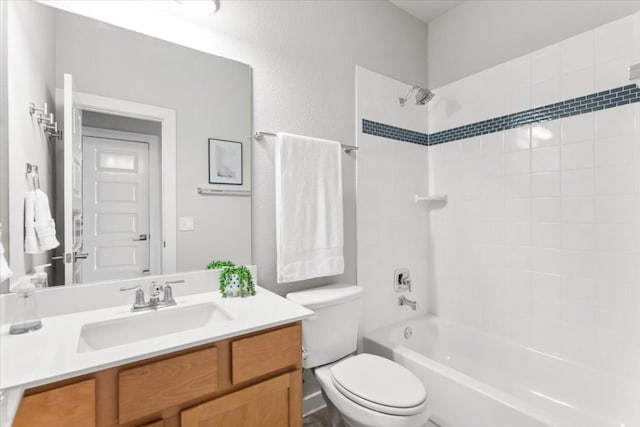 full bathroom featuring vanity, toilet, and tiled shower / bath