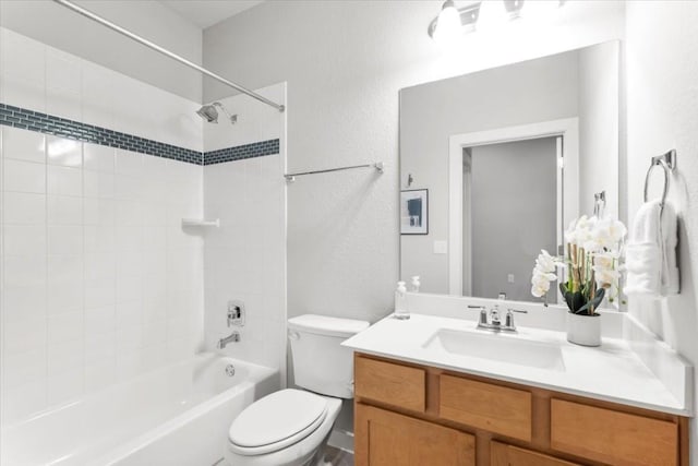 full bathroom with vanity, toilet, and tiled shower / bath