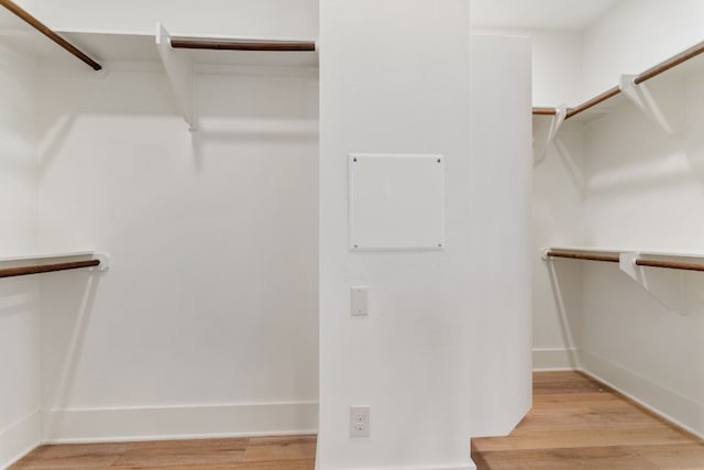 spacious closet with light hardwood / wood-style flooring