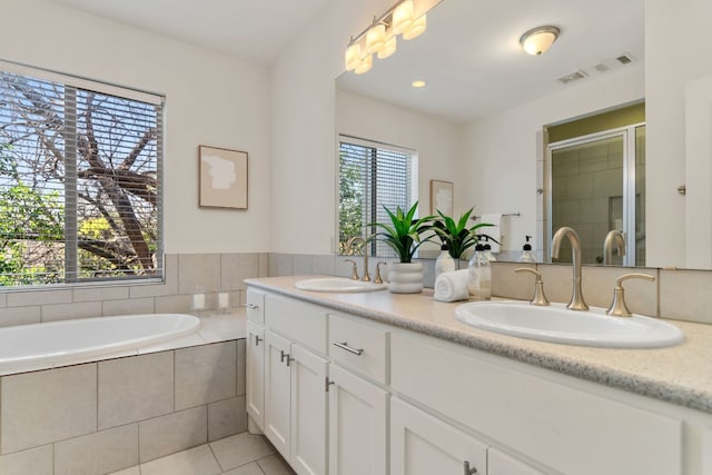 bathroom featuring vanity, tile patterned floors, and separate shower and tub