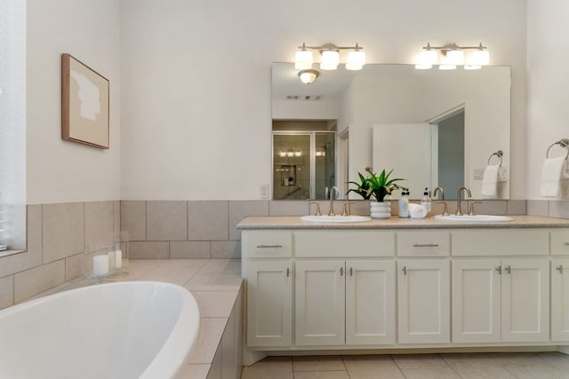 bathroom with tile patterned flooring, vanity, and separate shower and tub