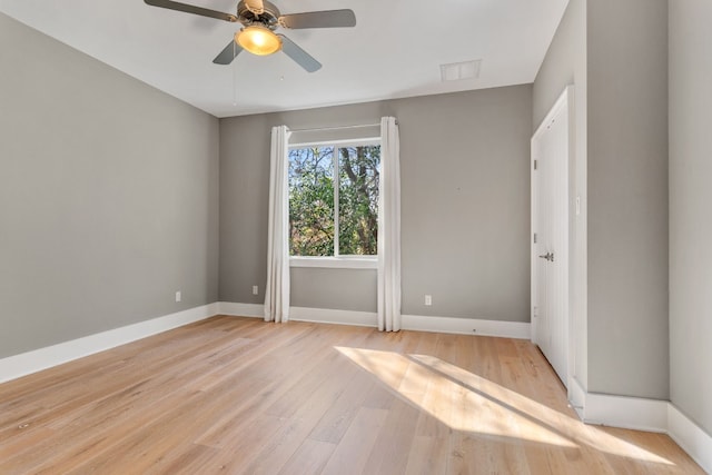 spare room with ceiling fan and light wood-type flooring