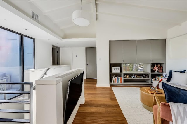 interior space with hardwood / wood-style floors and lofted ceiling with beams