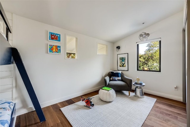 sitting room featuring lofted ceiling and hardwood / wood-style flooring