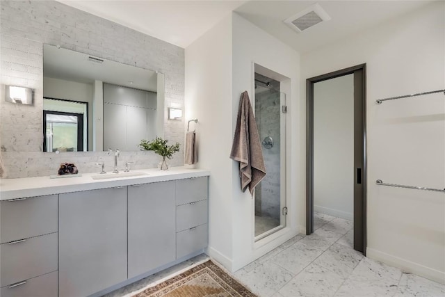 bathroom featuring vanity and a shower with door