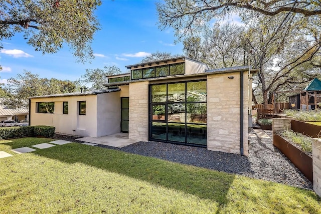 rear view of property with a lawn