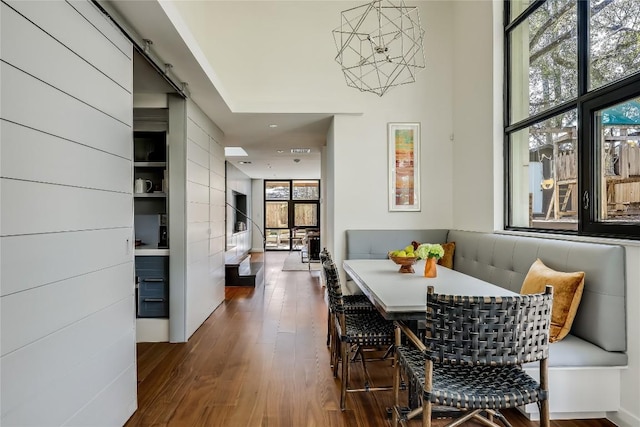 dining room with dark hardwood / wood-style flooring, breakfast area, and plenty of natural light