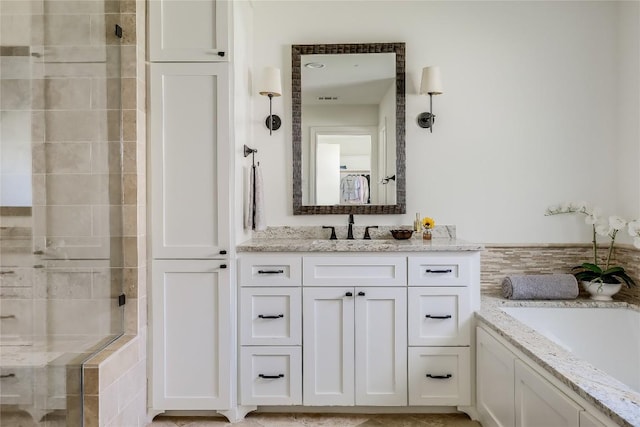 bathroom with separate shower and tub and vanity